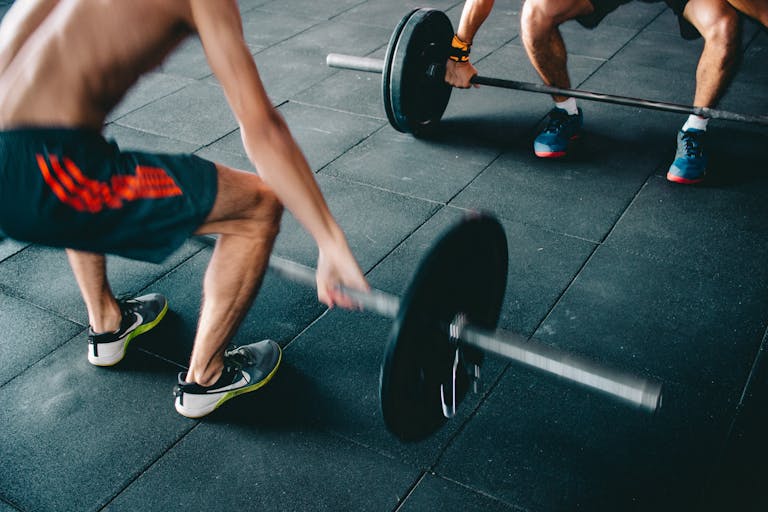 Man Wearing Black Shorts Lifting Heavy Barbells