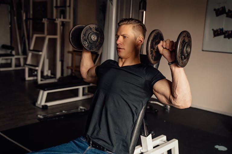 A Man Doing a Dumbbell Shoulder Press