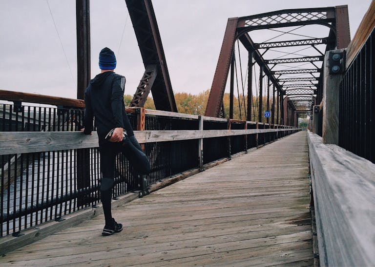 Man Standing on Bridge